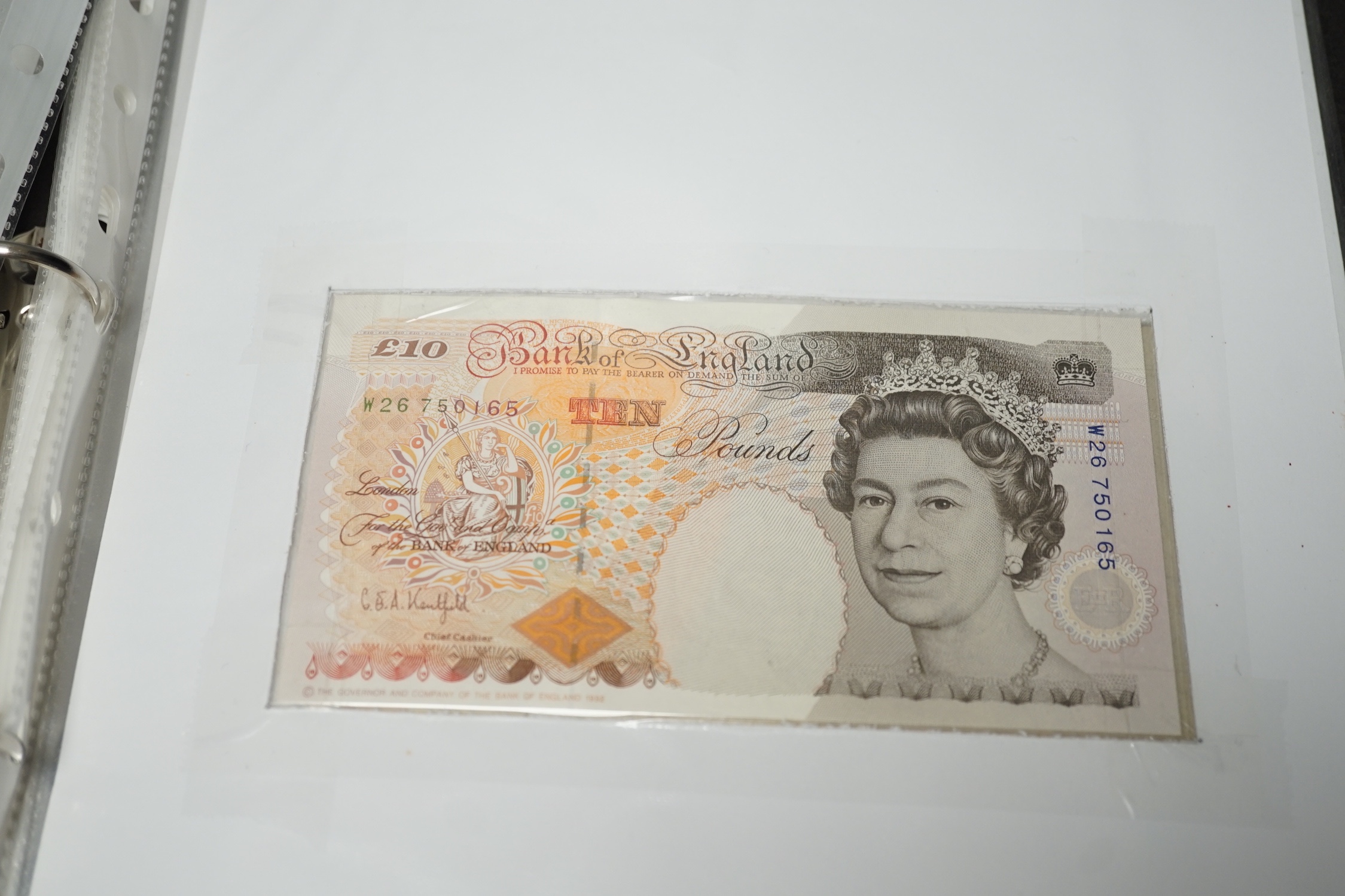 A collection of UK George V to Queen Elizabeth II banknotes, in an album